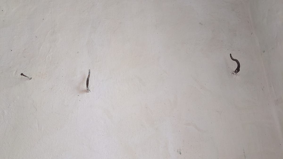 Iron hooks on Tower wall to hang your hat